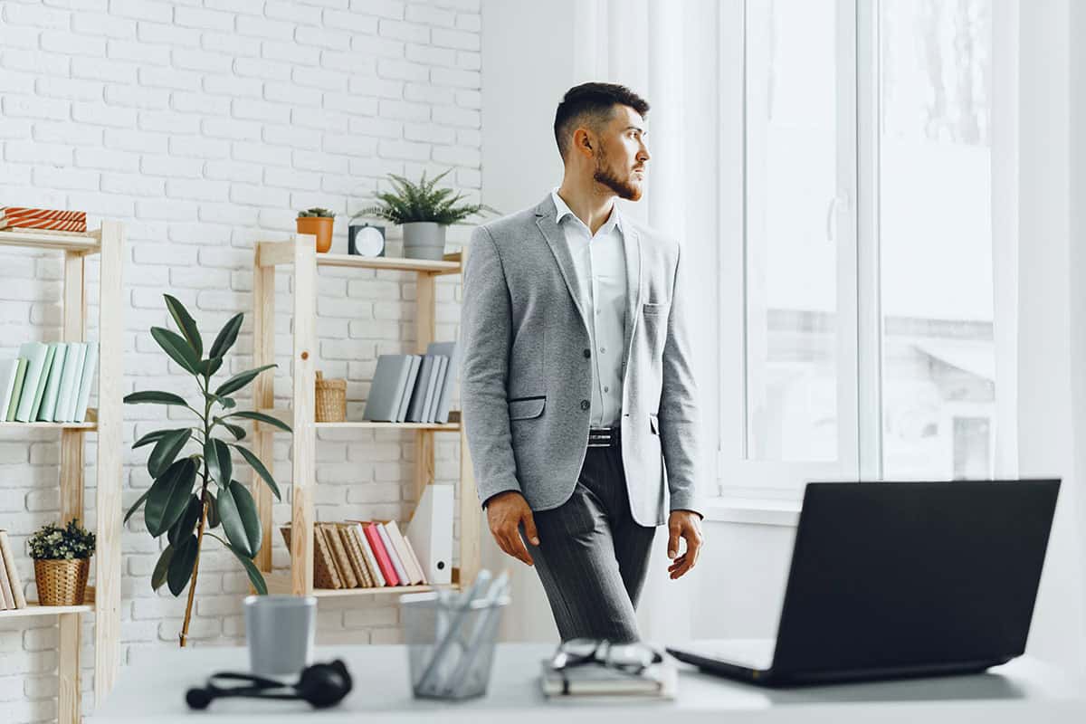 young-businessman-standing-by-the-window-at-his-of-2023-11-27-05-35-20-utc-copy.jpg